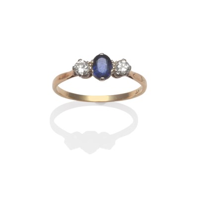 Lot 2159 - A Sapphire and Diamond Three Stone Ring, an oval mixed cut sapphire between two round brilliant cut