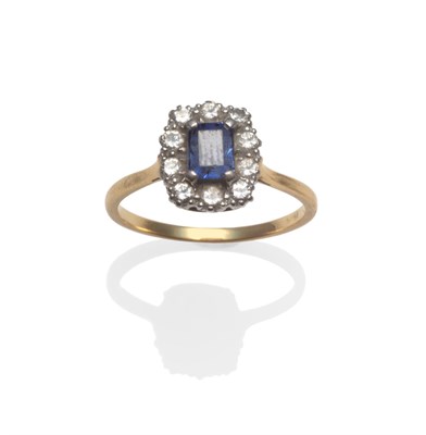 Lot 2162 - A Sapphire and Diamond Cluster Ring, an emerald cut sapphire within a border of round brilliant cut