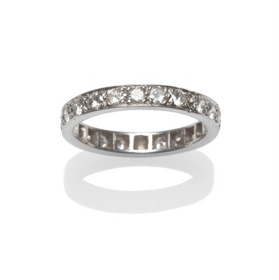 Lot 2201 - A Diamond Eternity Ring, the brilliant cut diamonds in claw settings to a flat sided shank,...