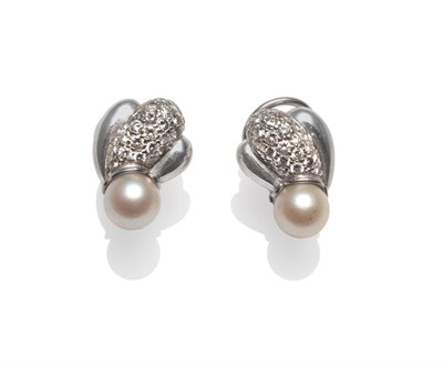 Lot 2202 - A Pair of Diamond and Cultured Pearl Studs, pavé set brilliant cut diamonds in a swirl motif, over