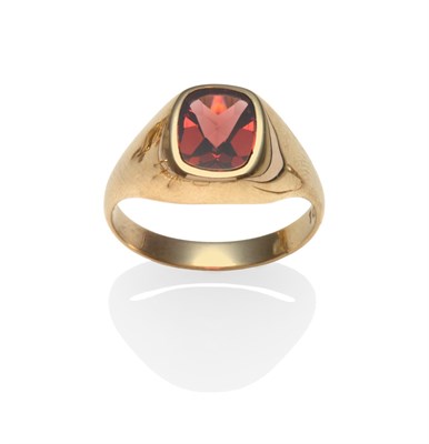 Lot 2208 - A 9 Carat Gold Garnet Signet Ring, the cushion cut fancy shaped garnet in a yellow rubbed over...