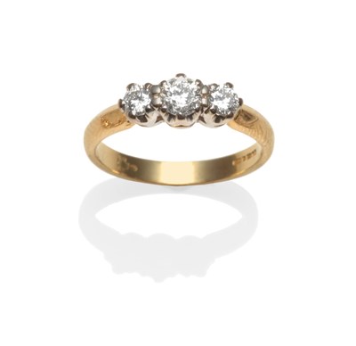 Lot 2212 - An 18 Carat Gold Diamond Three Stone Ring, the round brilliant cut diamonds in white claw settings