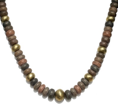 Lot 2217 - A Necklace, by Guy Royle, of graduated pebbles in grey and brown tones, spaced at intervals by...