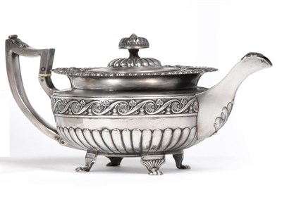 Lot 2322 - A George III Irish Silver Teapot, James Scott, Dublin 1817, of compressed form, chased with a...