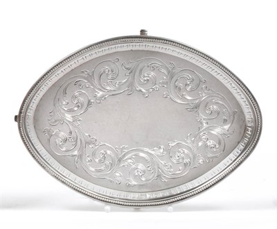 Lot 2344 - A George III Silver Teapot Stand, possibly John Kidder, London 1786, oval with flat chased...