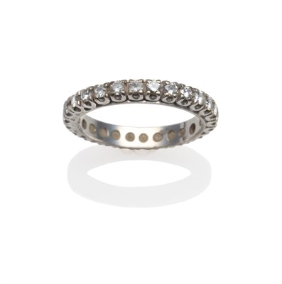 Lot 2000 - A Diamond Eternity Ring, the round brilliant cut diamonds in white claw settings to a flat...