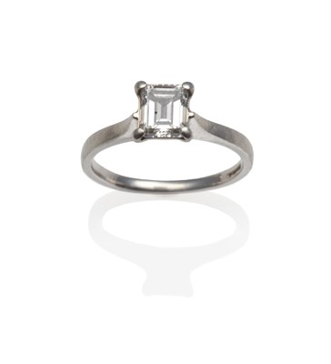 Lot 2005 - A Platinum Emerald-Cut Diamond Solitaire Ring, in a four claw setting, on a plain polished...