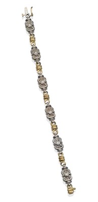 Lot 2006 - A Diamond Bracelet, white scroll links each with a round brilliant cut diamond in rubbed over...