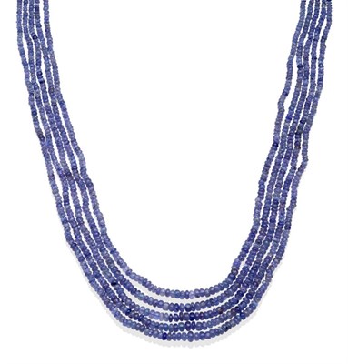 Lot 2007 - A Tanzanite Four String Necklace on Fabric Woven Mount, with graduating tumbled tanzanite beads...