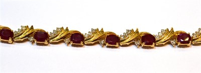 Lot 2013 - A Ruby and Diamond Bracelet, oval cut rubies and round brilliant cut diamonds in yellow claw...