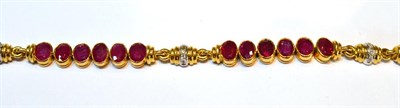 Lot 2015 - A Ruby and Diamond Bracelet, groups of oval cut rubies in yellow rubbed over settings, spaced...