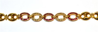 Lot 2016 - A Ruby and Diamond Bracelet, with three oval links set with round cut rubies, alternating with...