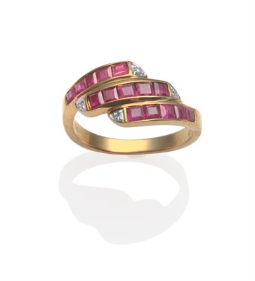 Lot 2018 - A Ruby and Diamond Three Row Ring, in crossover style, set with calibré cut rubies in three...