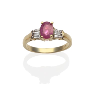 Lot 2019 - A Ruby and Diamond Ring, the oval-cut ruby in a yellow claw setting, shoulders each set with...