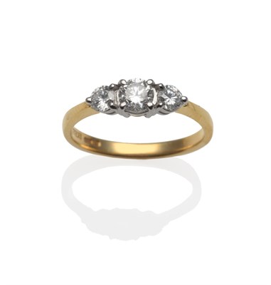 Lot 2037 - An 18 Carat Gold Diamond Three Stone Ring, graduated round brilliant cut diamonds in white claw...