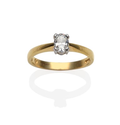 Lot 2040 - An 18 Carat Gold Oval Cut Diamond Solitaire Ring, in a white claw setting, on a plain polished...