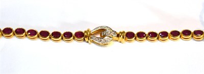 Lot 2046 - A Ruby and Diamond Bracelet, two sections of oval cut rubies in yellow rubbed over settings...