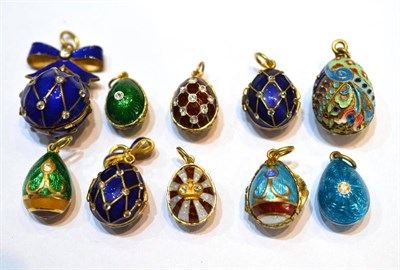 Lot 2047 - Nine Egg Charms and a Ball Charm, enamelled in assorted colours, some set with paste stones,...