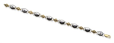 Lot 2057 - A Sapphire and Diamond Bracelet, with a calibré cut sapphire in white rubbed over setting,...