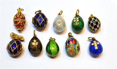 Lot 2061 - Ten Egg Charms, enamelled in assorted colours, some set with paste stones, some hinged to open