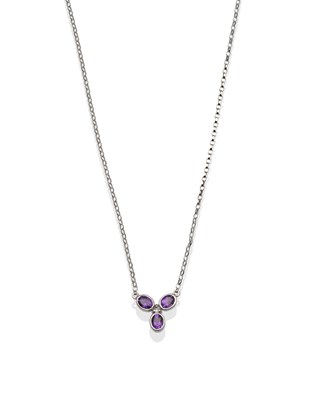 Lot 2064 - An Amethyst and Diamond Necklace, three oval cut amethysts in a white rubbed over setting in...