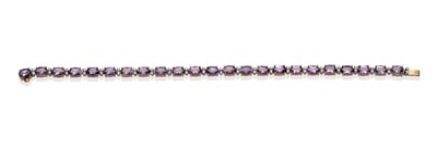 Lot 2071 - An Amethyst and Diamond Bracelet, oval cut amethysts spaced by pairs of round brilliant cut...