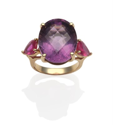 Lot 2072 - An Amethyst and Pink Stone Ring, an oval rose cut amethyst in yellow claw setting, flanked by...