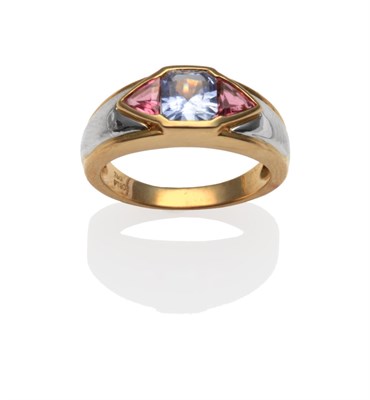 Lot 2074 - A Multi-Gemstone Ring, with an emerald-cut sapphire, flanked by trilliant-cut pink stones, in...