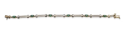 Lot 2075 - An Emerald and Diamond Bracelet, oval cut emeralds each flanked by round brilliant cut diamonds, in