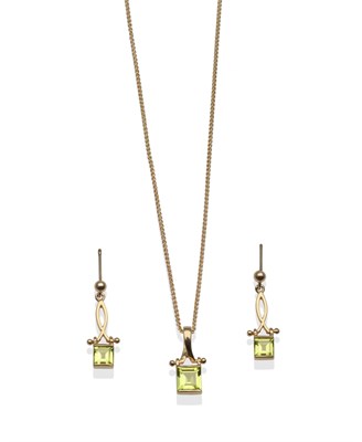 Lot 2080 - A 9 Carat Gold Peridot Pendant on Chain and a Pair of Peridot Drop Earrings, a calibré cut peridot