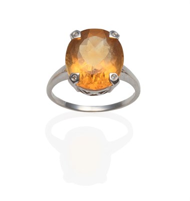 Lot 2081 - A Citrine and Diamond Ring, an oval cut citrine in white four-claw setting, each claw inset...