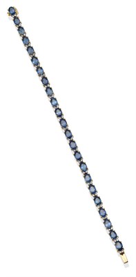 Lot 2084 - A Sapphire and Diamond Bracelet, oval cut sapphires spaced with pairs of round brilliant cut...