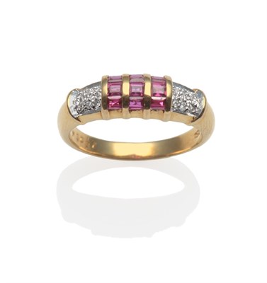 Lot 2088 - A Ruby and Diamond Ring, set with calibré cut rubies in a three row yellow channel setting,...