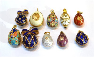 Lot 2092 - Ten Egg Charms, enamelled in assorted colours, some set with paste stones, some hinged to open