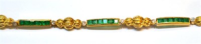 Lot 2093 - An Emerald and Diamond Bracelet, bar links set with calibré cut emeralds in yellow channel...