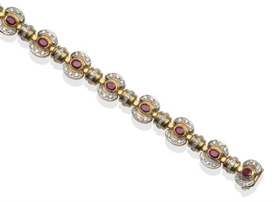 Lot 2095 - A Ruby and Diamond Bracelet, yellow links inset with oval rubies in a rubbed over setting with...