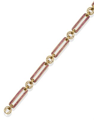 Lot 2097 - A Ruby and Diamond Bracelet, with double bar links of calibré cut rubies, alternating with...