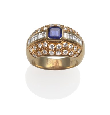 Lot 2107 - A Sapphire and Diamond Ring, the calibré cut sapphire in a yellow rubbed over setting, flanked...