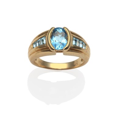 Lot 2108 - A Blue Topaz Ring, the oval-cut blue topaz in a yellow half rubbed over setting to shoulders...