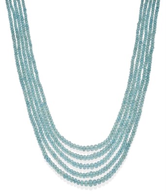 Lot 2109 - An Aquamarine Four String Necklace on Fabric Woven Mount, with graduating faceted aquamarine...