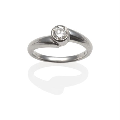 Lot 2112 - A Platinum Diamond Solitaire Ring, the round brilliant cut diamond in a rubbed over setting,...