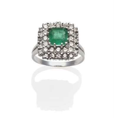 Lot 2113 - An Emerald and Diamond Ring, an emerald-cut emerald within a stepped border of round brilliant...