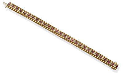 Lot 2118 - A Ruby and Diamond Bracelet, articulated yellow links each set with alternating pairs of round...