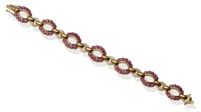 Lot 2122 - A Ruby Bracelet, with oval open work links set with pear cut rubies alternating with hoop links set