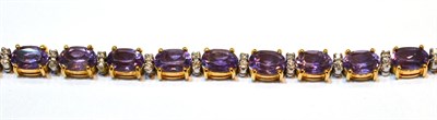 Lot 2132 - An Amethyst and Diamond Bracelet, oval cut amethysts spaced by pairs of round brilliant cut...