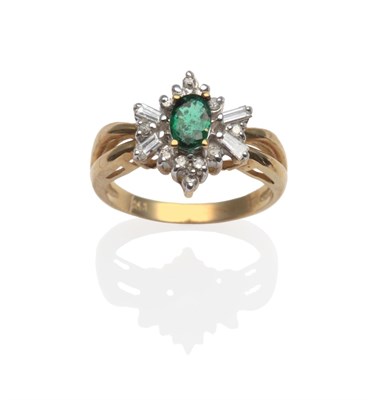 Lot 2141 - An Emerald and Diamond Ring, an oval emerald within a border of round cut and baguette cut diamonds