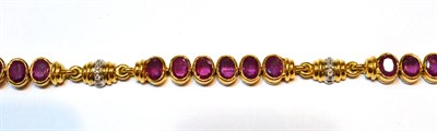 Lot 2145 - A Ruby Bracelet, oval cut rubies in yellow rubbed over settings alternate with diamond set...