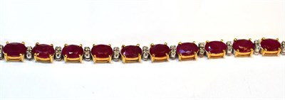 Lot 2146 - A Ruby Bracelet, oval cut rubies spaced by two pairs of round brilliant cut diamonds, in yellow...