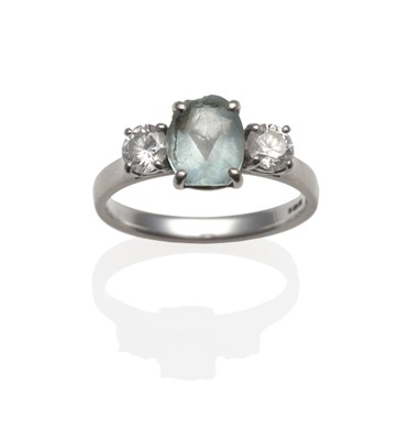 Lot 2150 - An 18 Carat White Gold Aquamarine and Diamond Three Stone Ring, an oval cut aquamarine flanked...