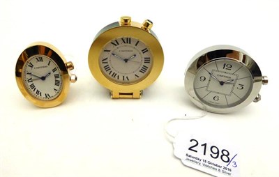 Lot 2198 - Three Alarm Travelling Timepieces, signed Cartier, circa 2010, the first, quartz movement,...